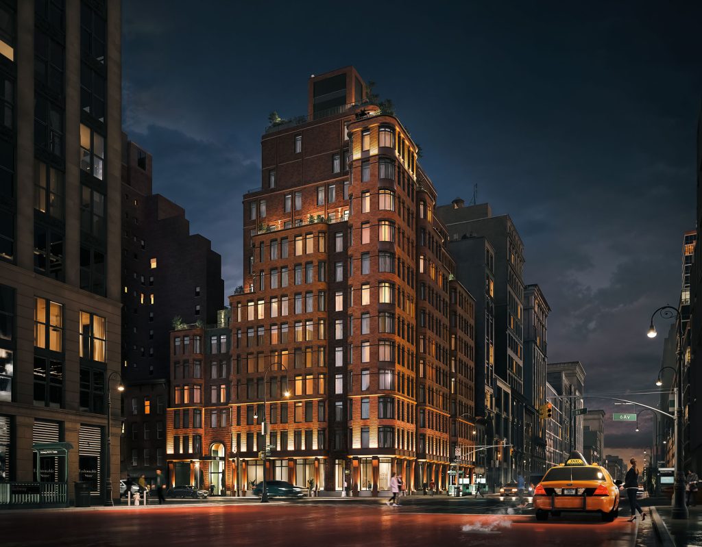 Street view of The Village West residences in NYC at night with the Manhattan skyline in the background.